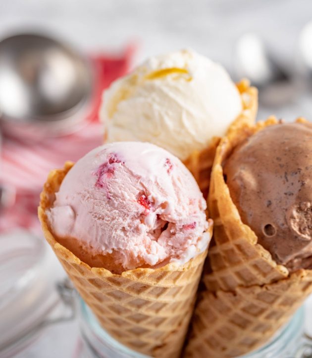 strawberry, vanilla, chocolate ice cream woth waffle cone on marble stone backgrounds